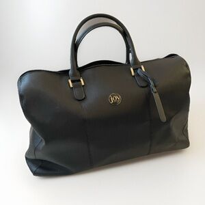 Black carry on duffle bag attaches to suitcase classic minimalist quiet luxury